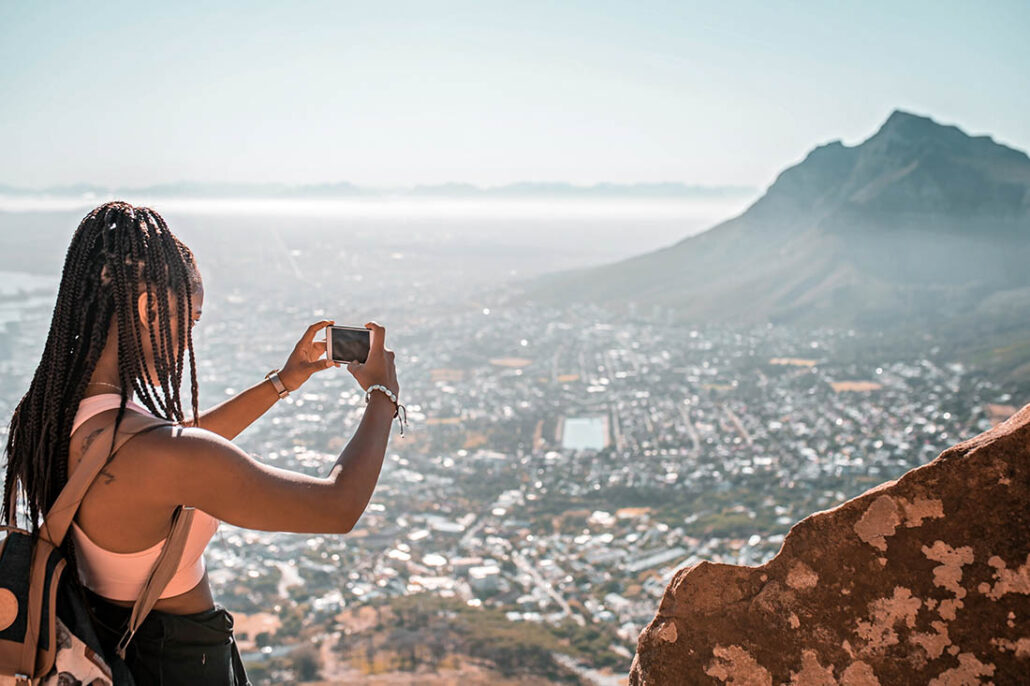 woman on vacation taking a picture at an exotic location 