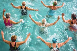 Active seniors in a lively water aerobics class