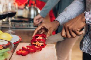 Man chops vegetables for a heart-healthy plant-based meal for someone with type 2 diabetes