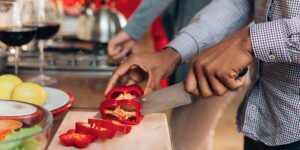Man chops vegetables for a heart-healthy plant-based meal for someone with type 2 diabetes
