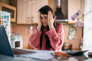 Woman overwhelmed with the financial burden and stress of a medical diagnosis