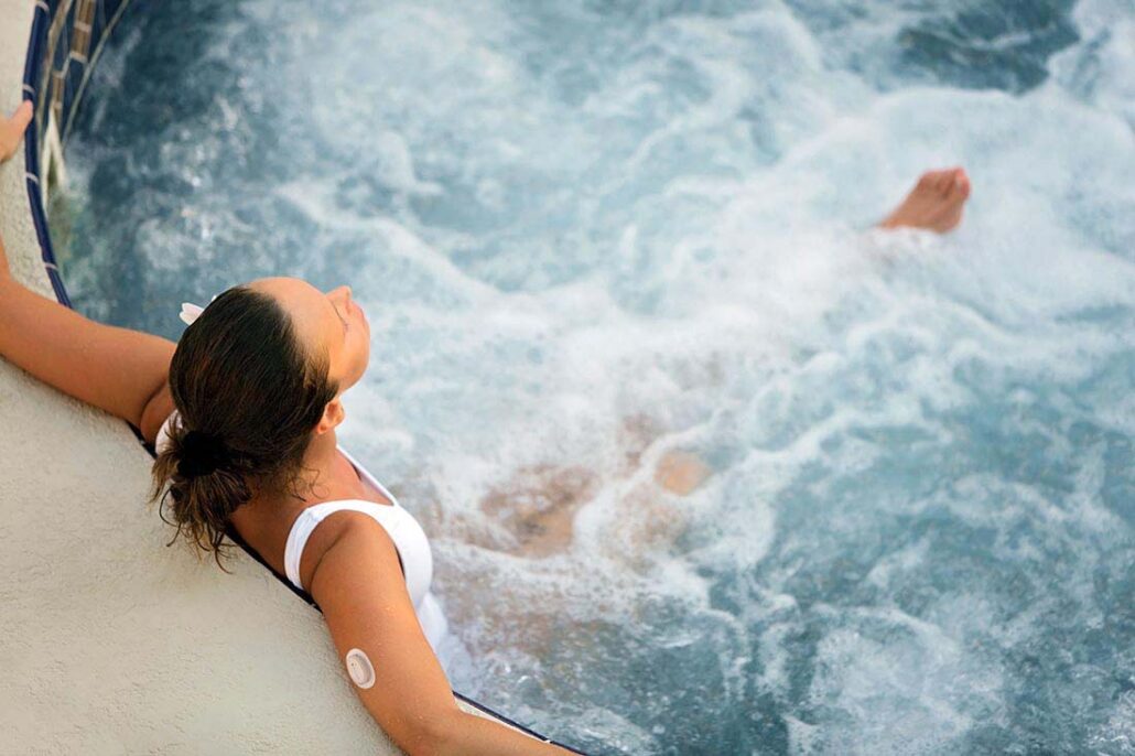 A person with type 1 diabetes in a hot tub aware of possible blood sugar changes