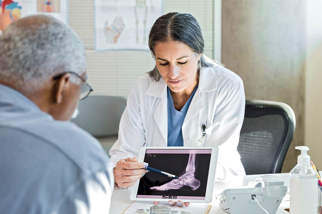Doctor explains bone health to patient with diabetes and osteoporosis