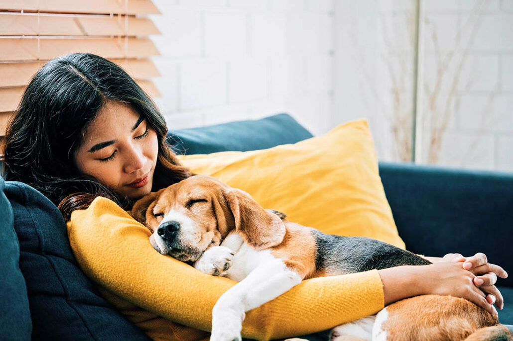 Woman rests with her dog for quality sleep and improved quality of life