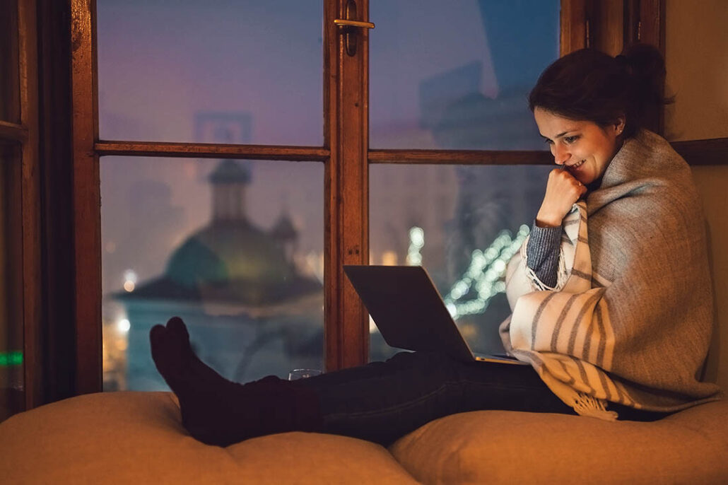 Woman taking time for herself and mental wellness reading on laptop