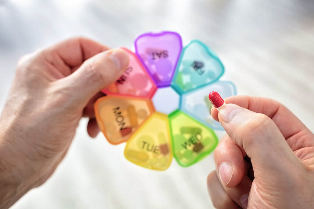 A person with diabetes organizing medication pill box