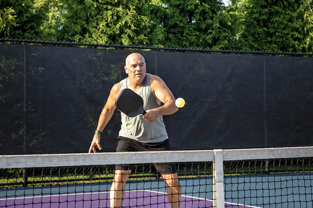 Middle-aged man with type 2 diabetes playing pickleball for exercise