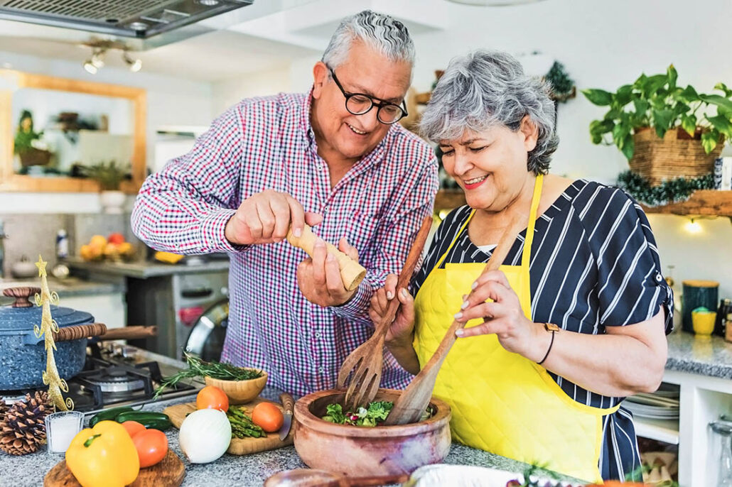 husband and wife making a healthy dinner together