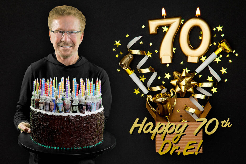 Dr. Edelman holding up a cake for his 70th birthday