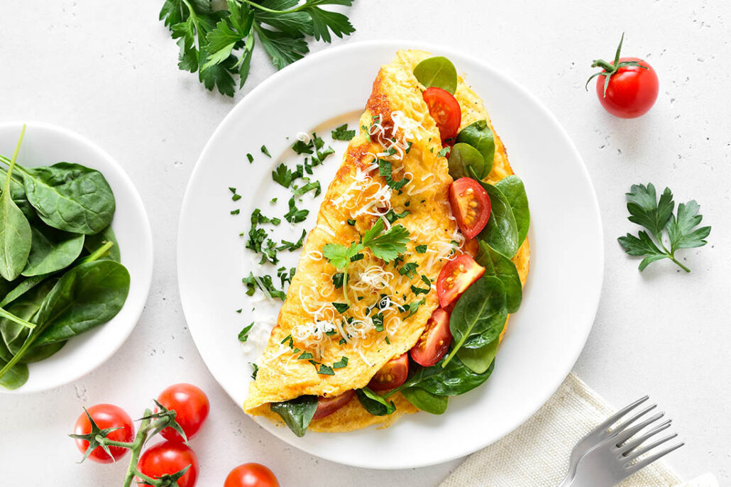 Omelet stuffed with vegetables as a good source of protein for breakfast on Thanksgiving