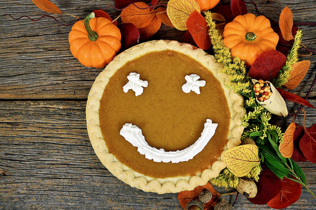 Thanksgiving pumpkin pie with whipped cream in a smiley face