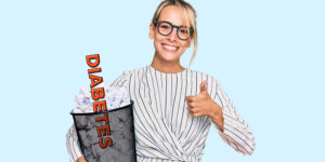 Attractive woman holding a garbage can with the word diabetes in it