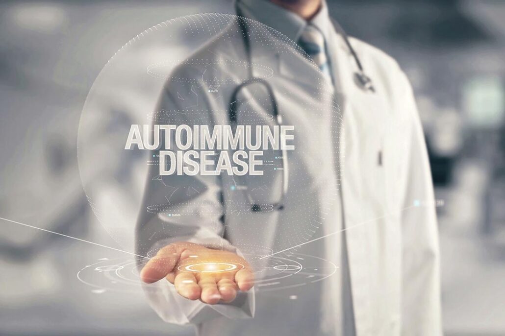 A doctor in a white lab coat with his hand underneath the words autoimmune disease