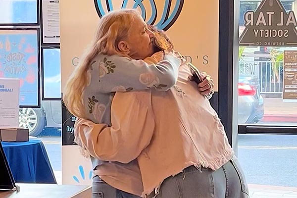 Two adult women hugging